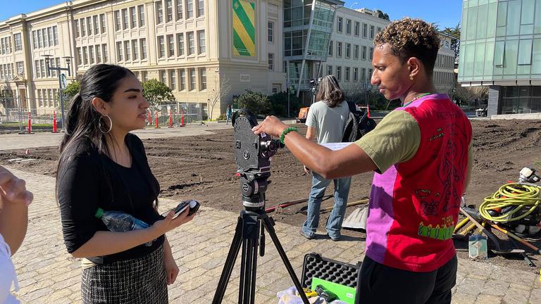 Two USF students filming on campus for class