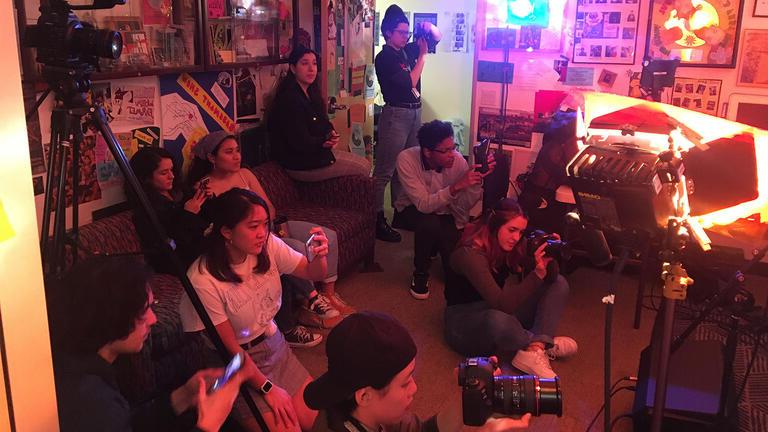 Group of USF students filming for class in a dorm room